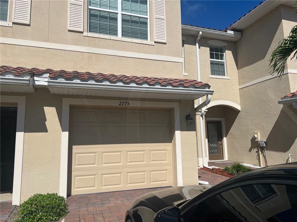 2775 Citrus Street Naples, FL 34120 - Photo 2 of 31 a front view of a house with a balcony