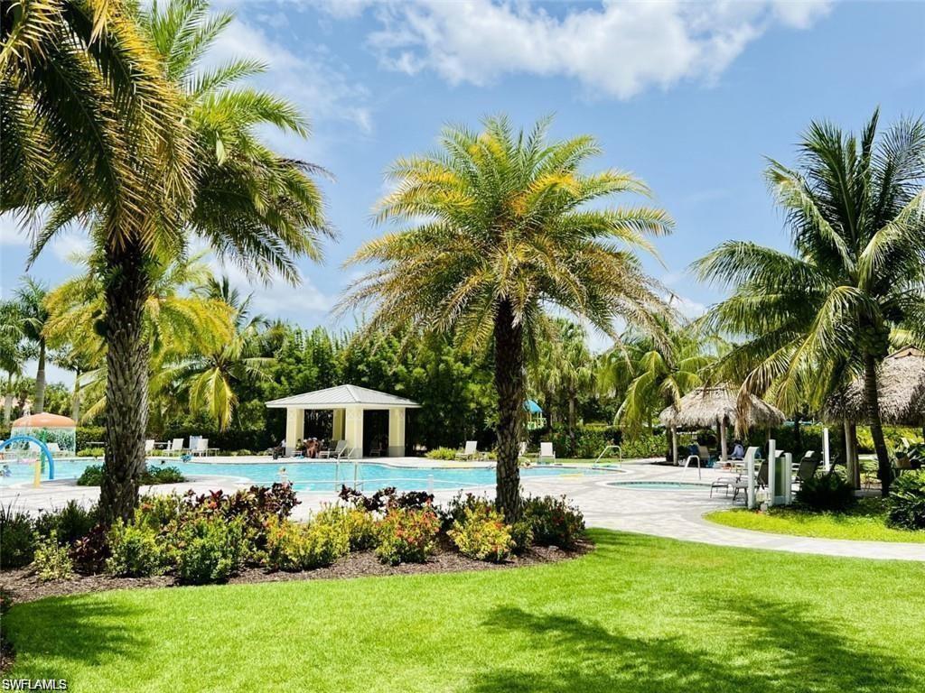 2775 Citrus Street Naples, FL 34120 - Photo 24 of 31 a view of house with swimming pool and tall trees