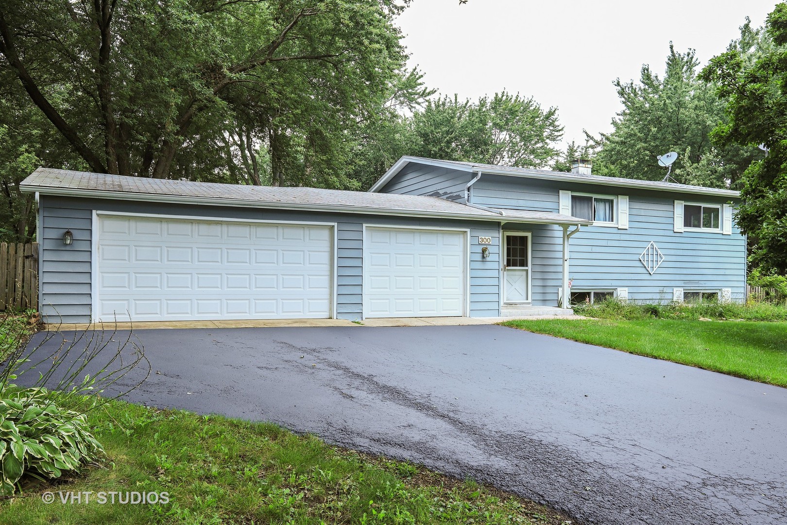 300 High Road Cary, IL 60013 - Photo 1 of 10 a front view of a house with a yard and garage