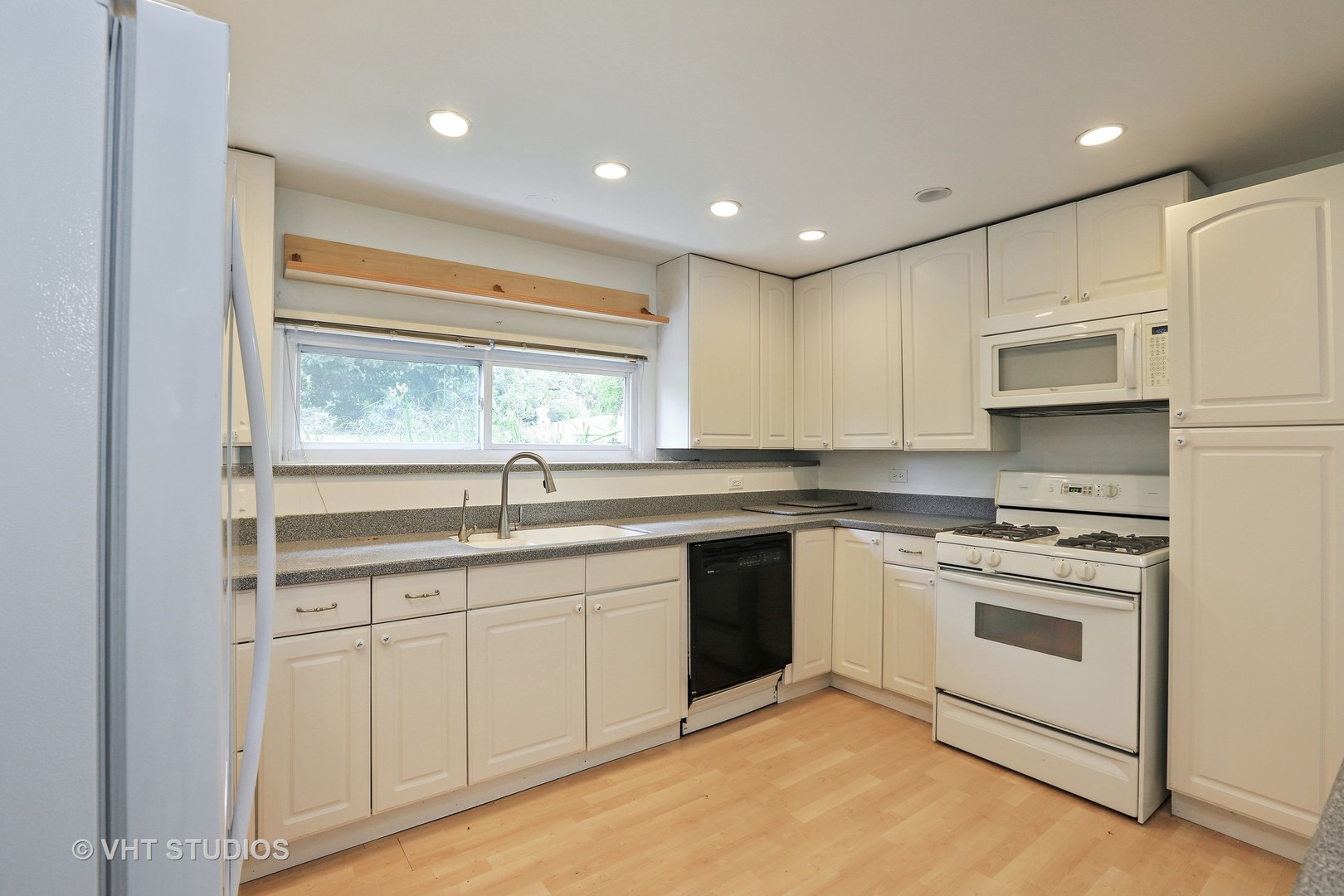 300 High Road Cary, IL 60013 - Photo 4 of 10 a kitchen with a sink stove and cabinets