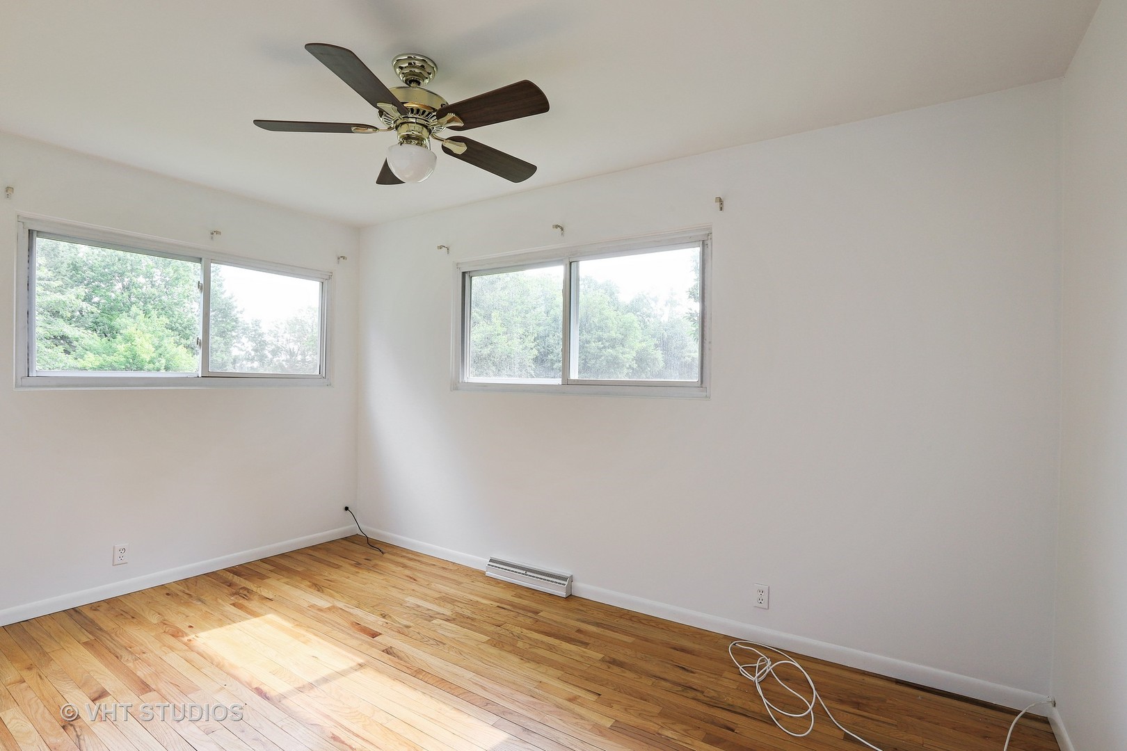 300 High Road Cary, IL 60013 - Photo 7 of 10 a view of empty room with wooden floor and ceiling fan