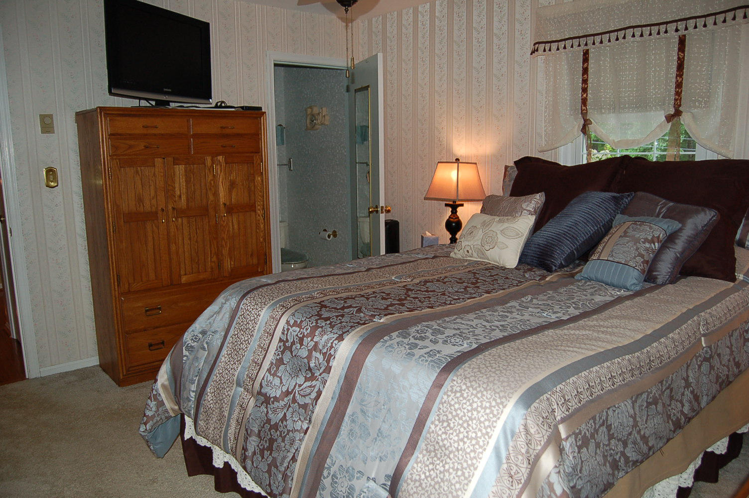 384 Pin Oak Drive Blue Ridge, VA 24064 - Photo 24 of 57 a bedroom with a bed and a flat screen tv