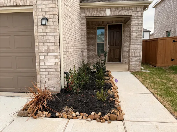 a view of a brick house with a yard