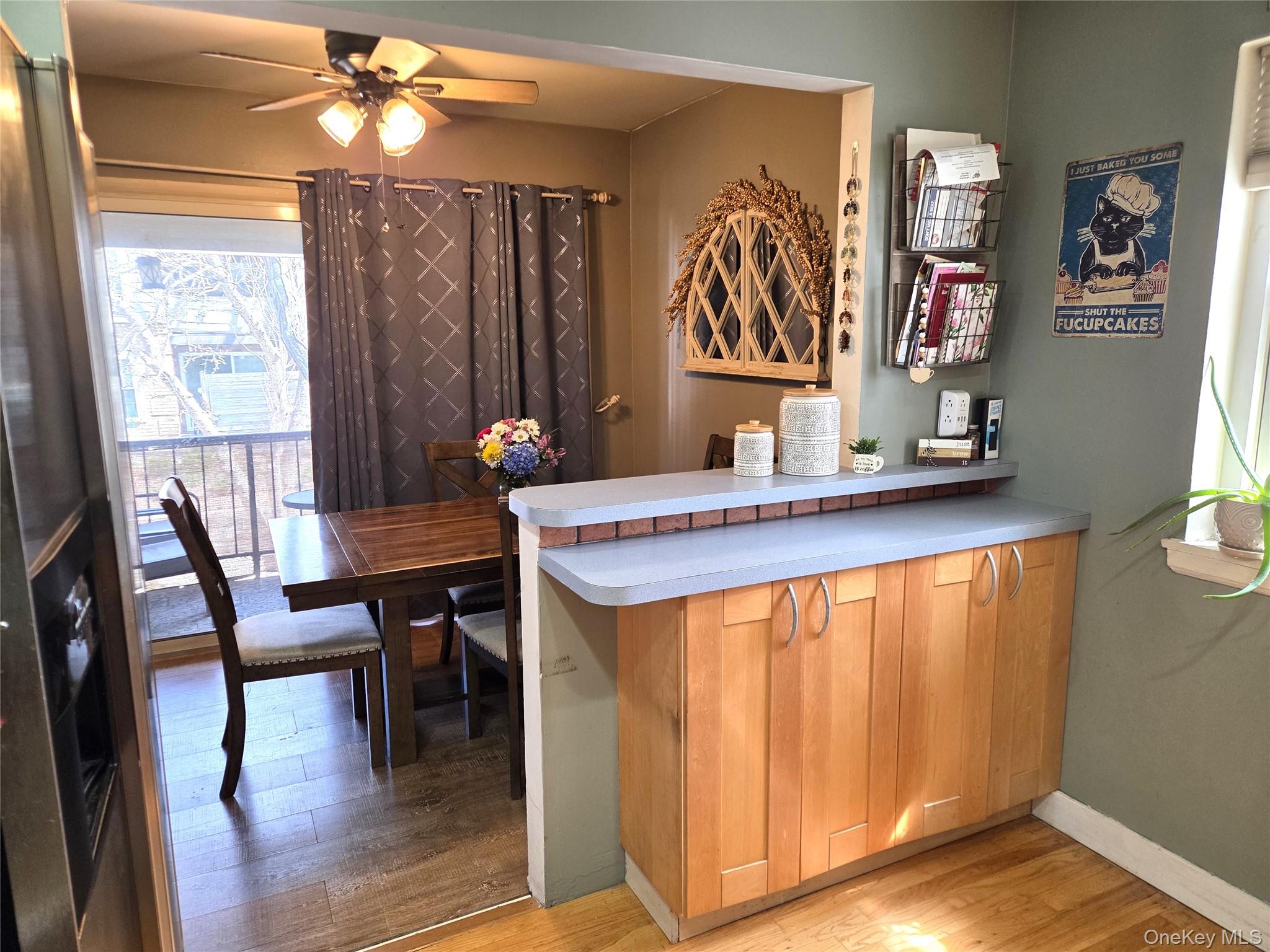 655 Middle Country Road, Unit 6A2 Coram, NY 11727 - Photo 11 of 19 The Dining Room Opens Into The Kitchen With A Half Wall/Counter & Serving Space And Additional Storage Cabinetry Below. Open & Airy, And Perfect For Preparing & Serving Meals