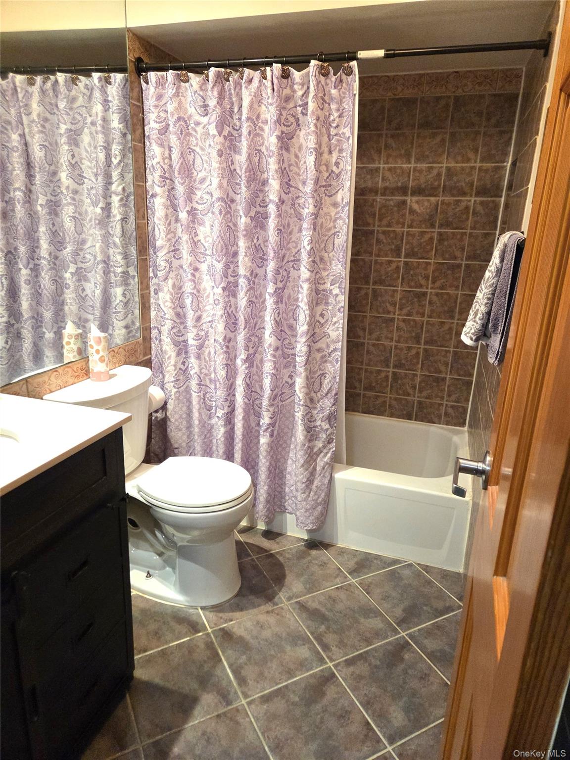 655 Middle Country Road, Unit 6A2 Coram, NY 11727 - Photo 15 of 19 The Updated Bathroom Offers Diagonal Ceramic Tiled Floors, A Full Bathtub With All Fully Ceramic Tiled Walls, Halfway Ceramic Tiled Walls Around The Rest Of The Bathroom With A Decorative Border, Updated Vanity & Fixtures.