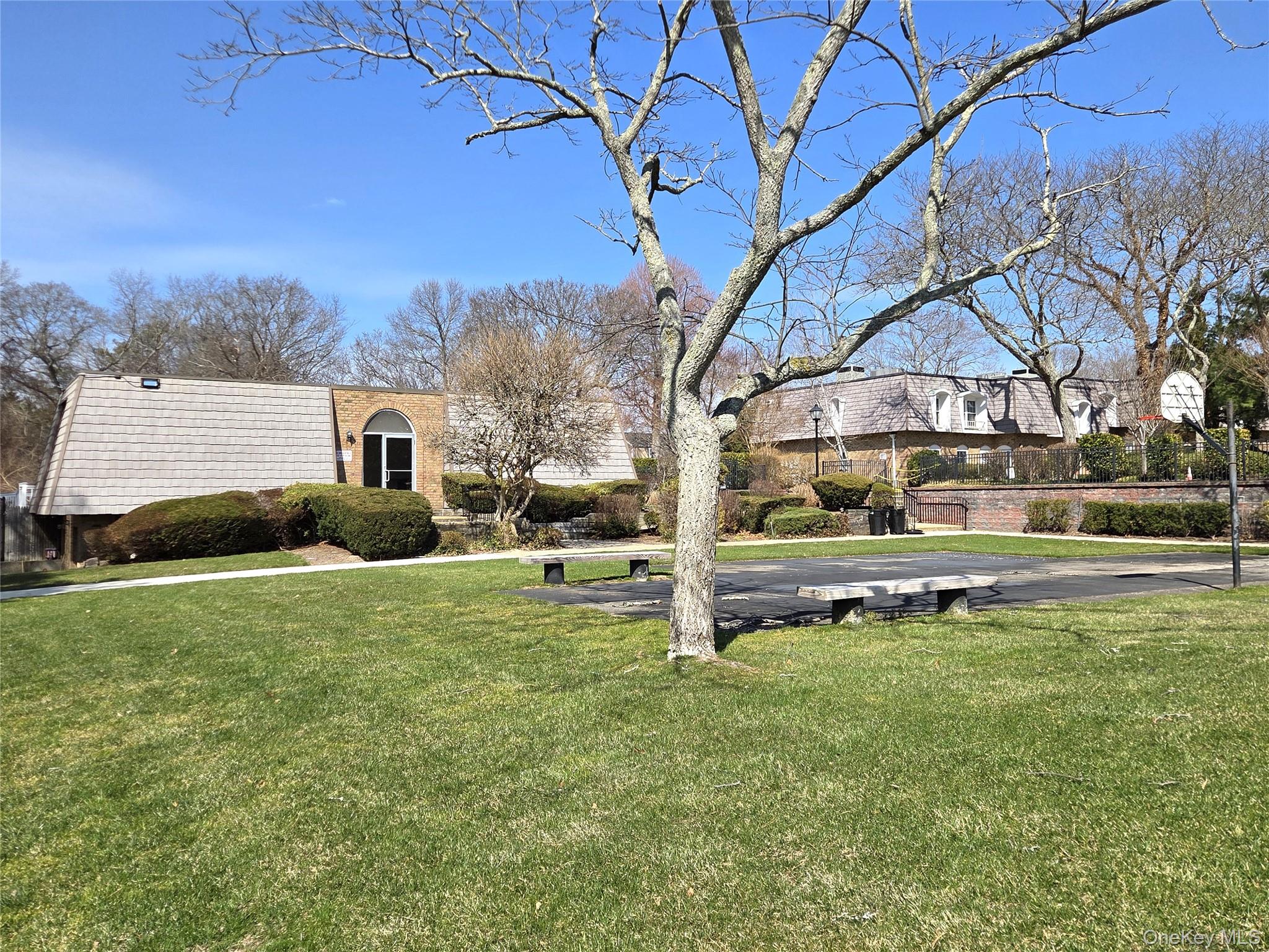 655 Middle Country Road, Unit 6A2 Coram, NY 11727 - Photo 16 of 19 View Of The Community Clubhouse, Basketball Court & Beautifully Manicured Lawns & Open Spaces Within The Community