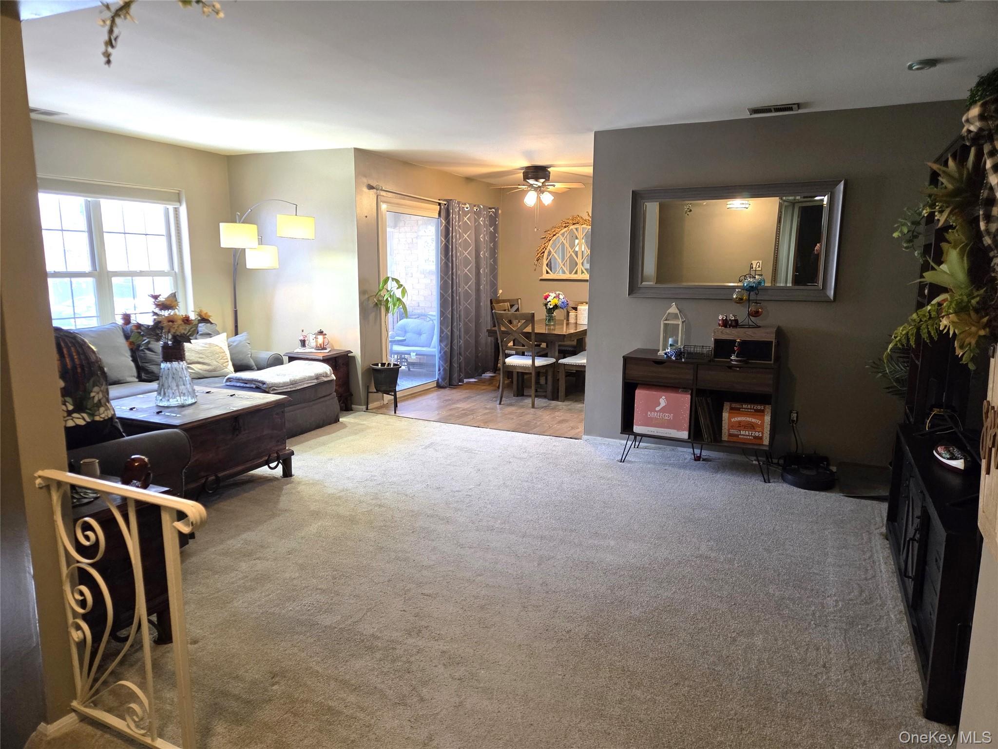 655 Middle Country Road, Unit 6A2 Coram, NY 11727 - Photo 6 of 19 The Stairway Opens Into The Very Large Open Living Room & Dining Room...The Living Room Offers Ample Room For A Large Living Room Set/Furniture & A Double Window For Natural Light.