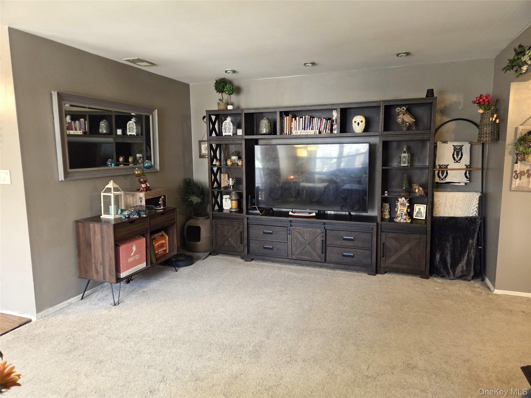 655 Middle Country Road, Unit 6A2 Coram, NY 11727 - Photo 9 of 19 The Other Side Of The Living Room Offers Ample Room For A Large Entertainment Center/TV Cabinet Or More Room For Seating/Entertaining.