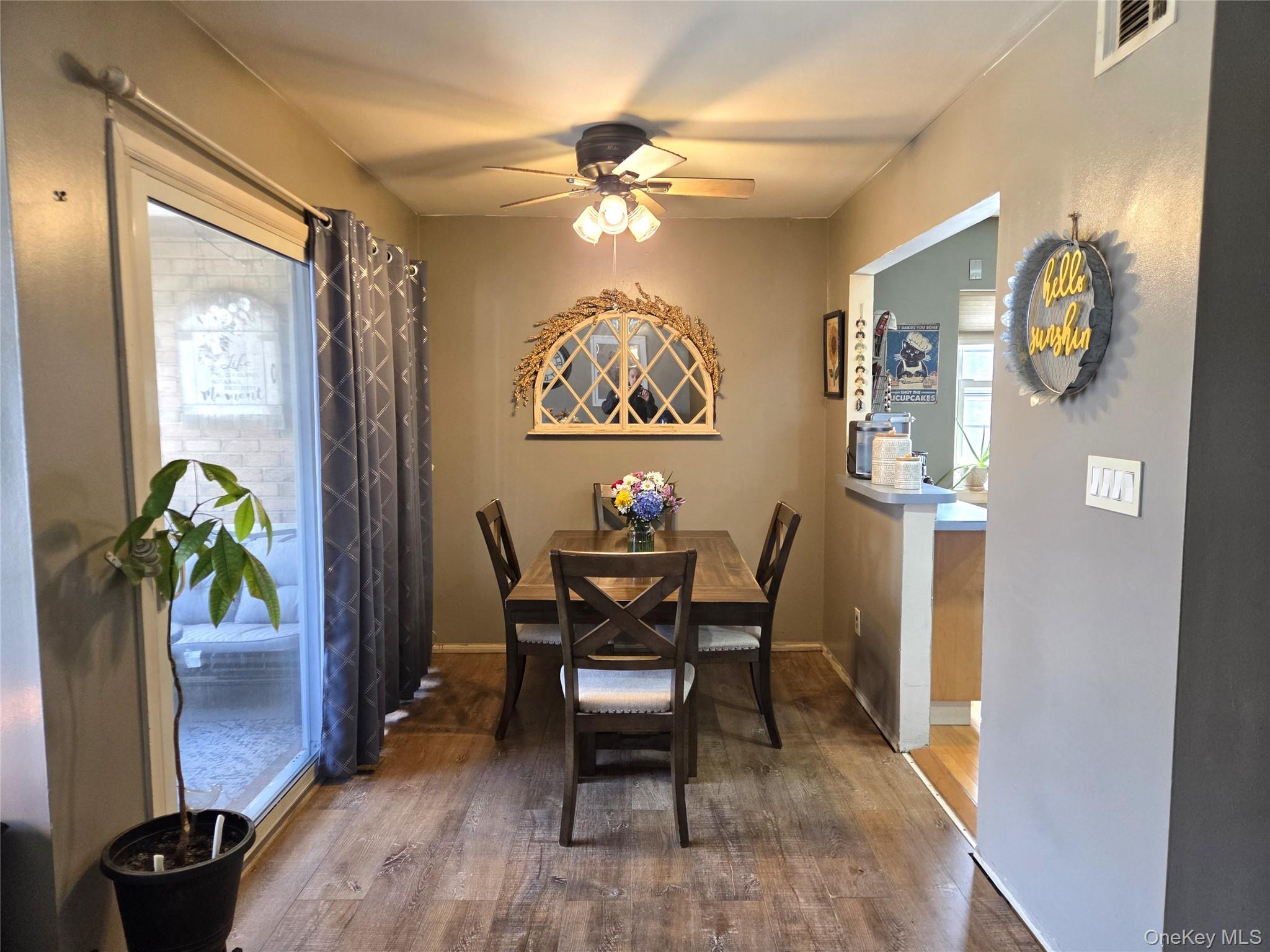 655 Middle Country Road, Unit 6A2 Coram, NY 11727 - Photo 10 of 19 The Inviting Formal Dining Room Offers Manufactured Hardwood Flooring, Sliding Doors To A Lovely Terrace, Ample Room For A Large Table & Chairs, Ceiling Fan & Opens Into The Kitchen. A Perfect Flow From The Living Room Into The Dining Room, And Into The Kitchen - Perfect for Entertaining!