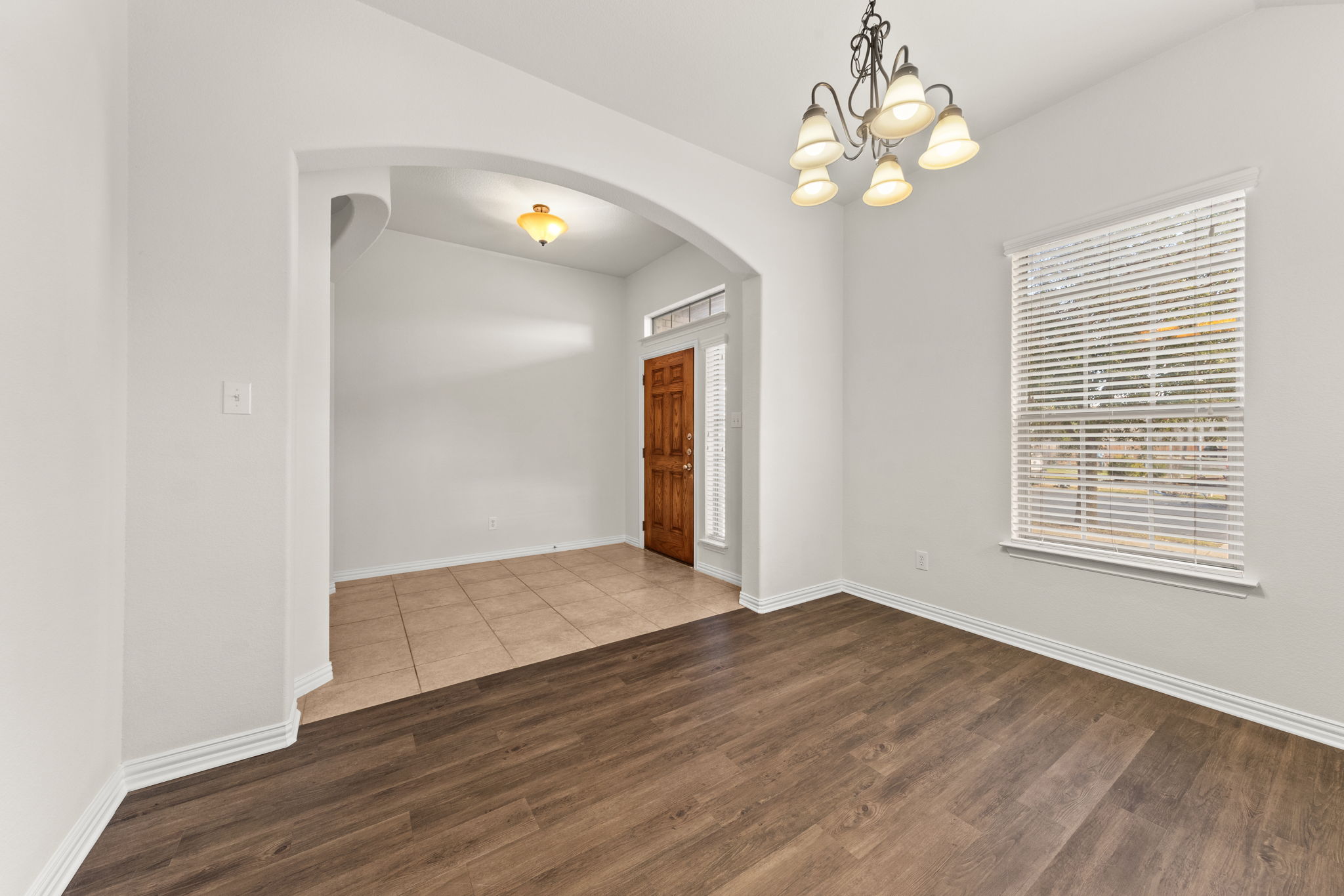 411 Tascate Street Georgetown, TX 78628 - Photo 8 of 41 An inviting entry opens to a spacious room with rich hardwood floors, ready for personal touches.