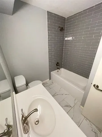 a bathroom with a bathtub and shower
