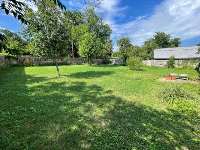 a view of a park with large trees