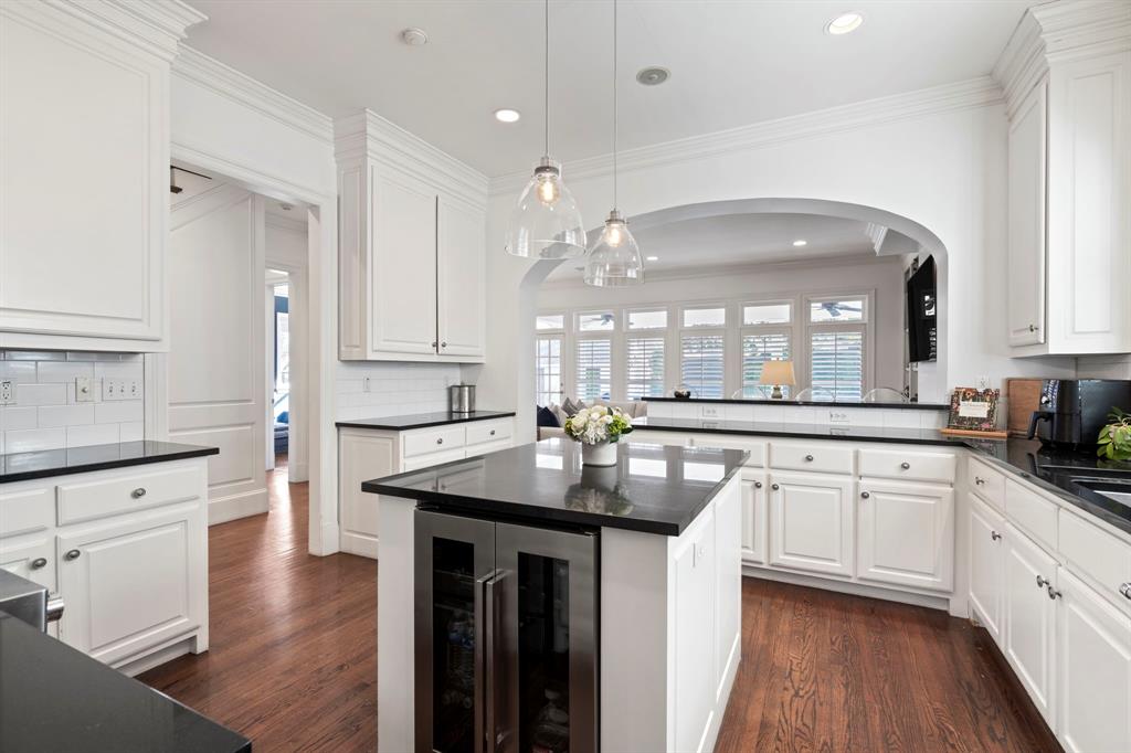 6936 Pasadena Avenue Dallas, TX 75214 - Photo 11 of 39 a kitchen with stainless steel appliances granite countertop a sink stove and white cabinets with wooden floor