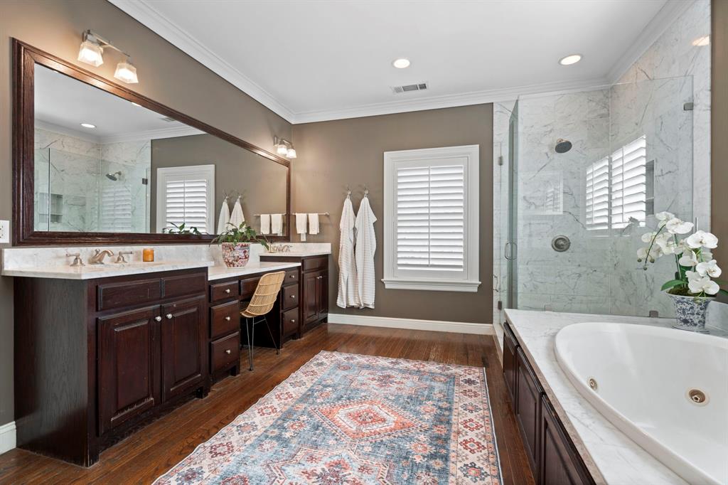 6936 Pasadena Avenue Dallas, TX 75214 - Photo 20 of 39 a spacious bathroom with a tub sink and mirror