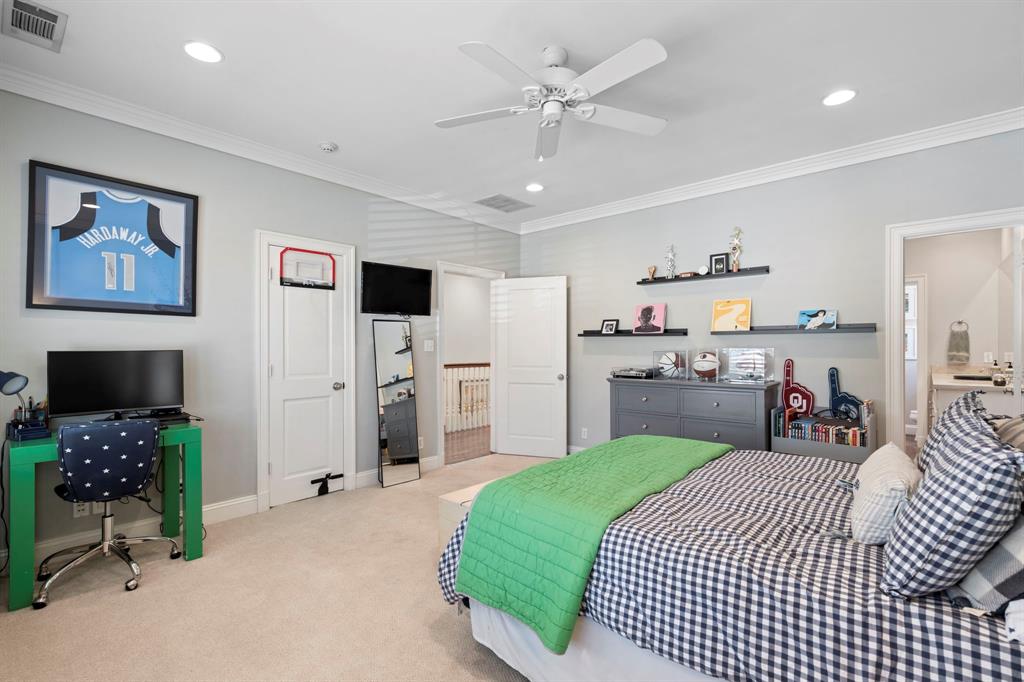 6936 Pasadena Avenue Dallas, TX 75214 - Photo 23 of 39 a bedroom with a bed and a television in it