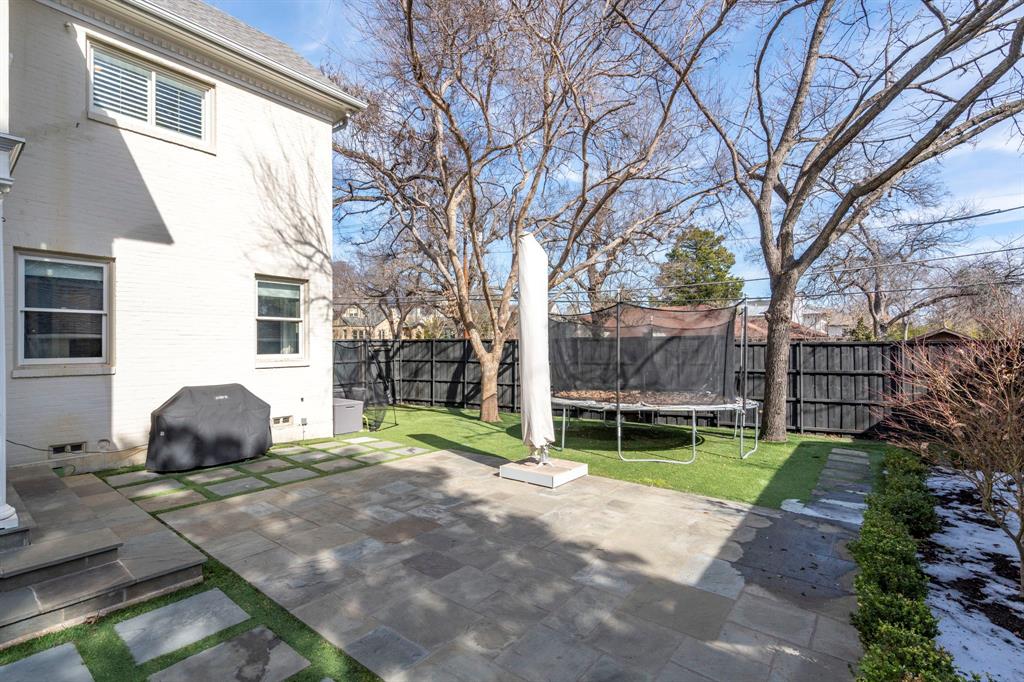 6936 Pasadena Avenue Dallas, TX 75214 - Photo 39 of 39 a backyard of a house with potted plants and large tree