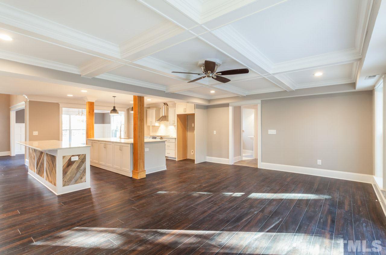 3329 Lake Boone Trail Raleigh, NC 27607 - Photo 8 of 25 a view of an empty room with wooden floor and a ceiling fan