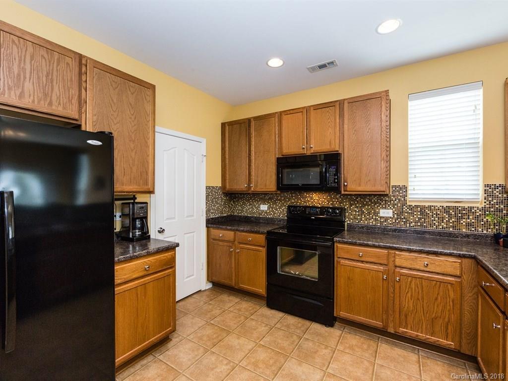 257 River Clay Road Fort Mill, SC 29708 - Photo 3 of 11 a kitchen with stainless steel appliances granite countertop a stove a refrigerator and a sink