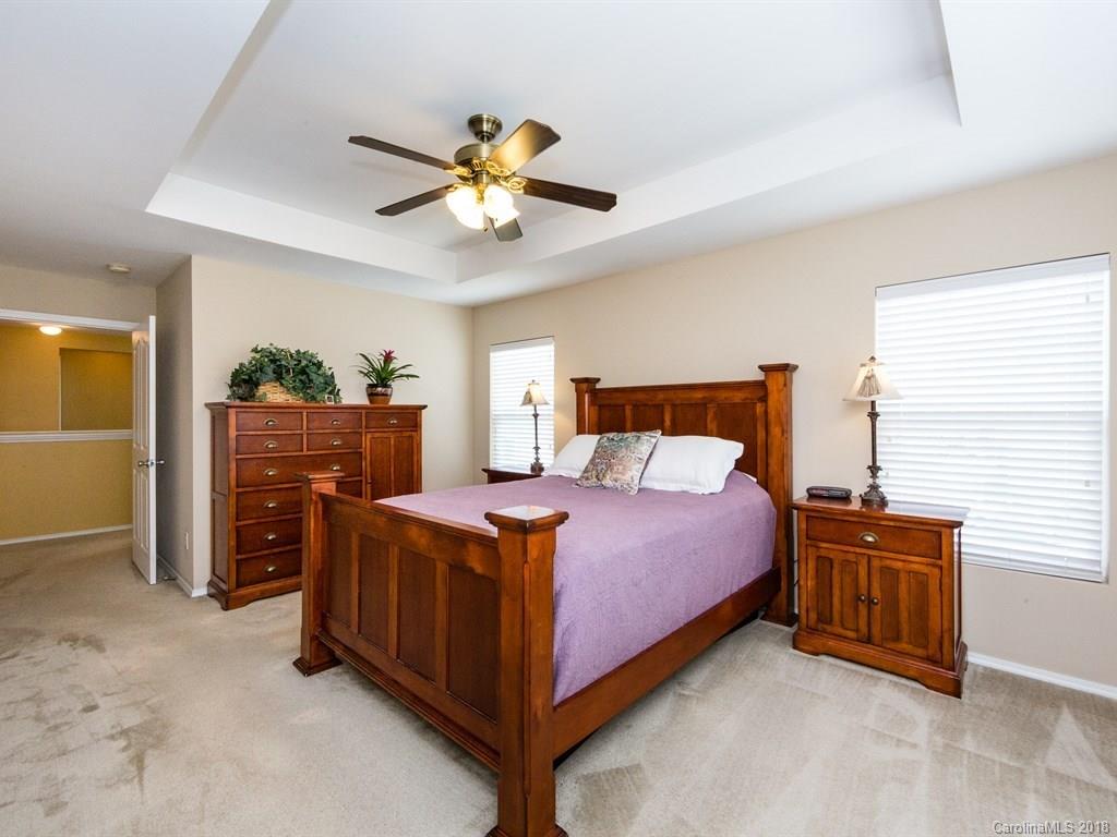 257 River Clay Road Fort Mill, SC 29708 - Photo 7 of 11 a bedroom with a bed and a chandelier
