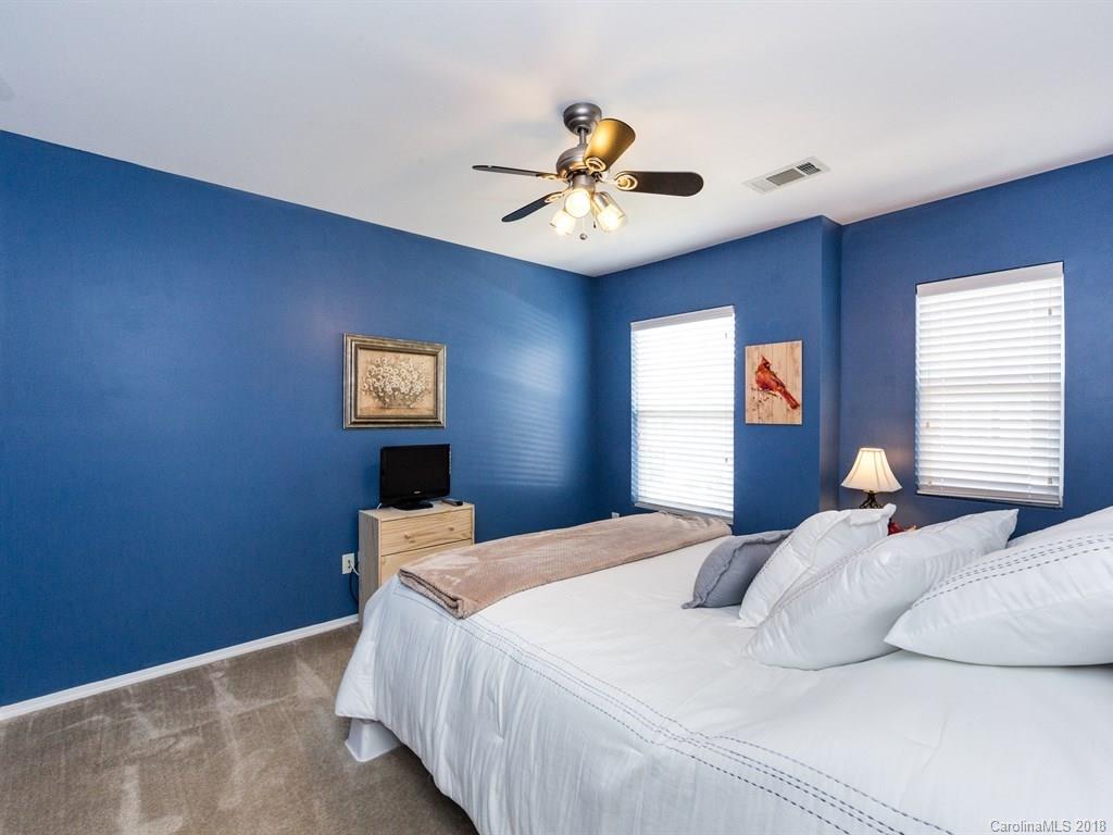 257 River Clay Road Fort Mill, SC 29708 - Photo 8 of 11 a bedroom with a bed and a chandelier