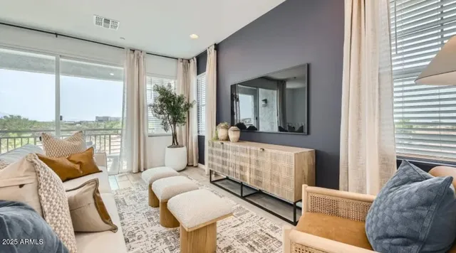 a living room with furniture and a dining table with wooden floor