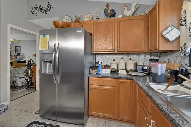 a kitchen with stainless steel appliances granite countertop a refrigerator sink and cabinets