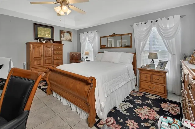 a bedroom with a bed dresser and window