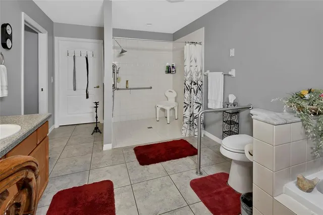 a bathroom with a sink a toilet and shower