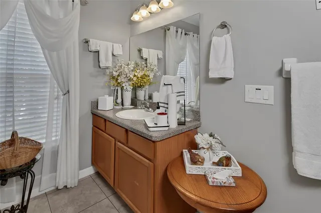 a bathroom with sink a mirror a toilet and shower curtain
