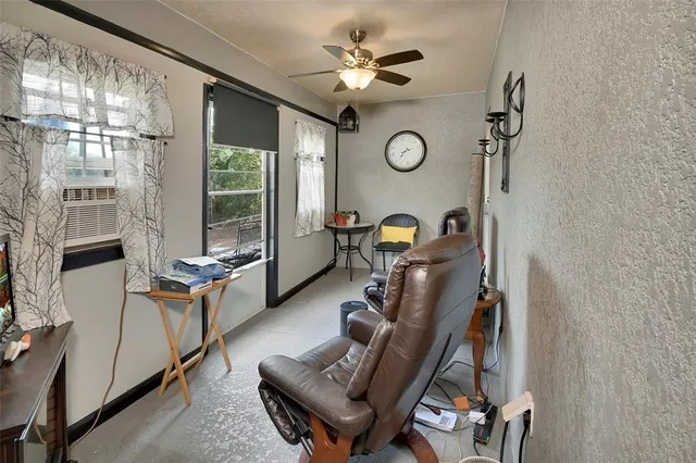 a view of a workspace with furniture and a window