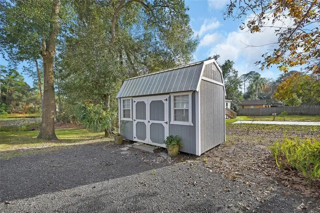 a view of a barn in the middle of a yard