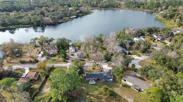 an aerial view of residential house with outdoor space and lake view