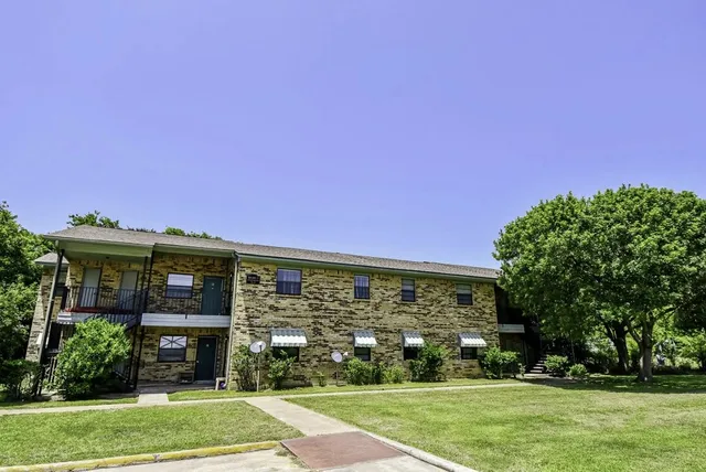 a front view of a building with garden