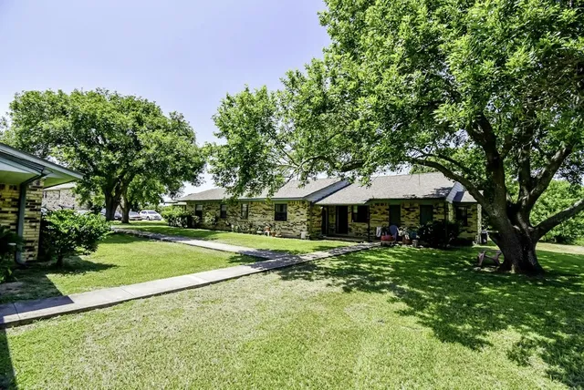 a front view of a house with a yard garage and outdoor seating