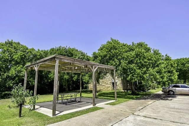 a view of a house with a yard and a porch