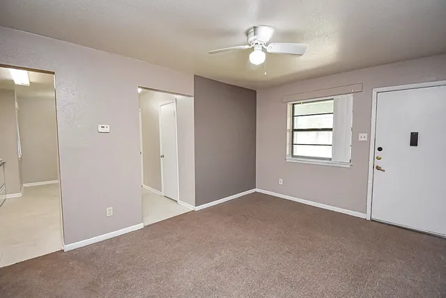 a view of an empty room with a window