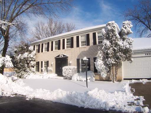 2804 Farmington Road Northbrook, IL 60062 - Photo 1 of 1 a view of a white house with a yard covered in snow