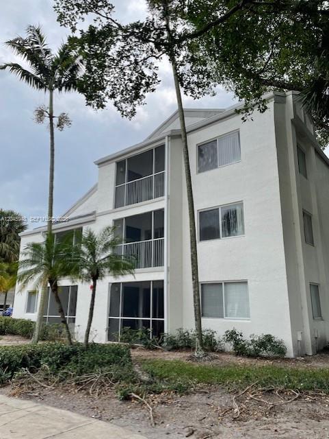 5612 Rock Island Road, Unit 167 Tamarac, FL 33319 - Photo 1 of 16 a front view of a house with garden