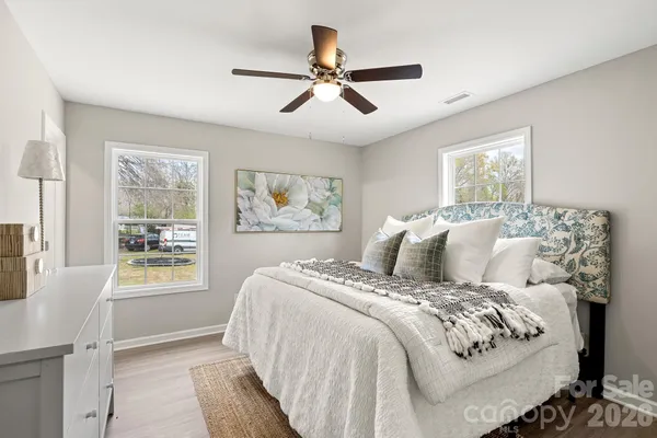a bedroom with a large bed and a window