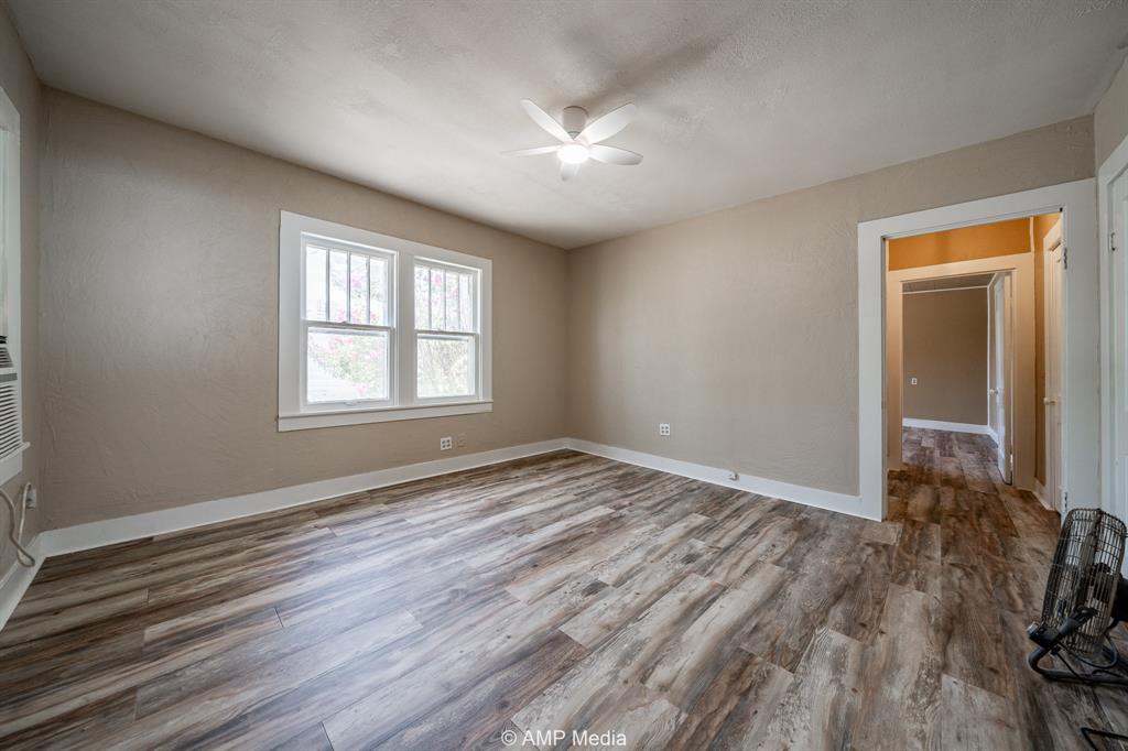 1726 Avenue J Anson, TX 79501 - Photo 11 of 13 a view of an empty room with wooden floor and a window