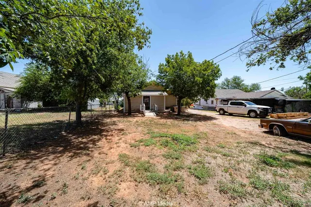 a view of a house with a yard covered in snow