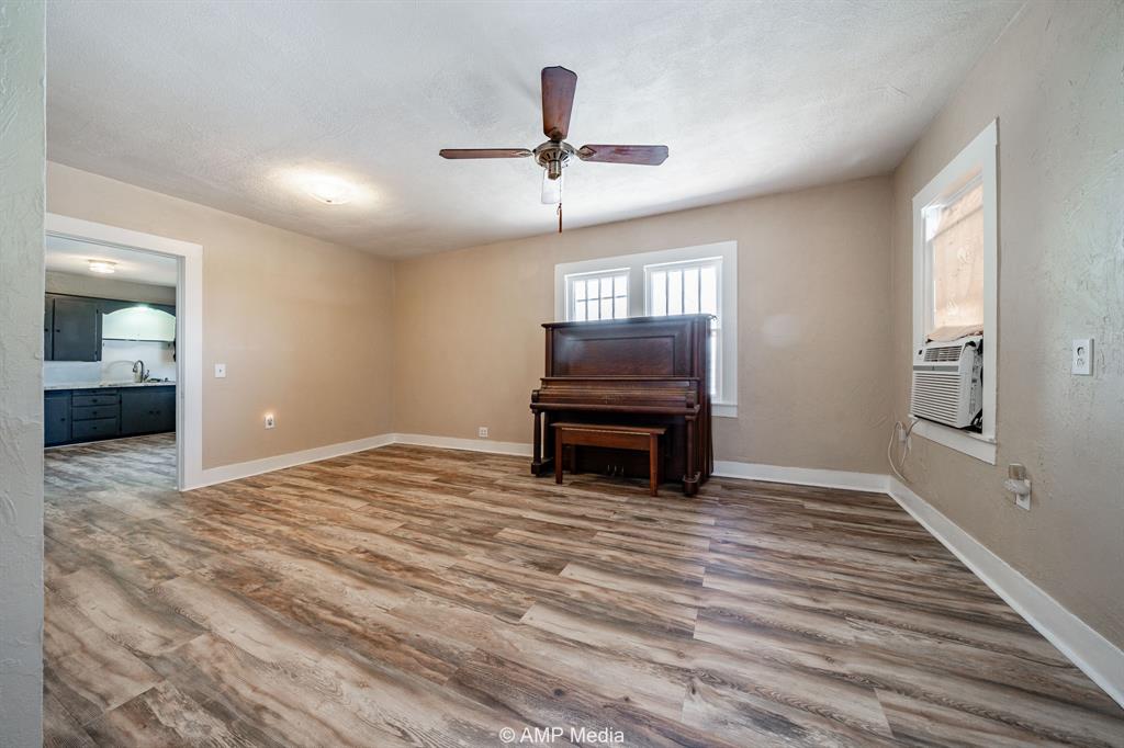 1726 Avenue J Anson, TX 79501 - Photo 2 of 13 a view of empty room with wooden floor and fan