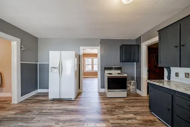 a kitchen with a refrigerator and a sink
