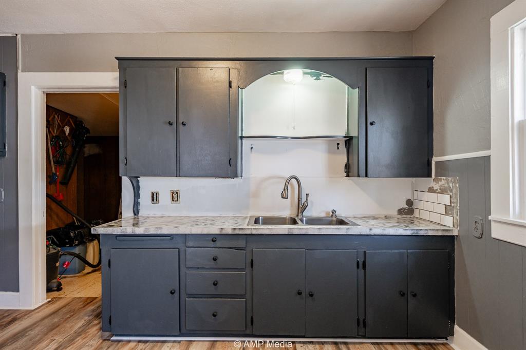 1726 Avenue J Anson, TX 79501 - Photo 5 of 13 a bathroom with a granite countertop sink and a mirror