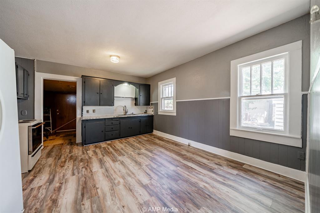 1726 Avenue J Anson, TX 79501 - Photo 6 of 13 a kitchen with a refrigerator and a sink