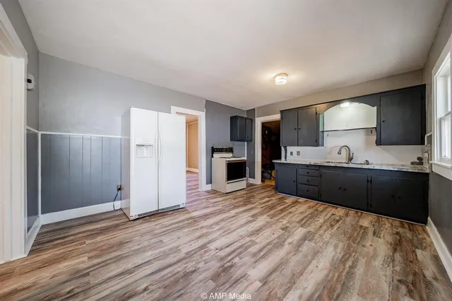 a view of kitchen with refrigerator microwave and cabinets