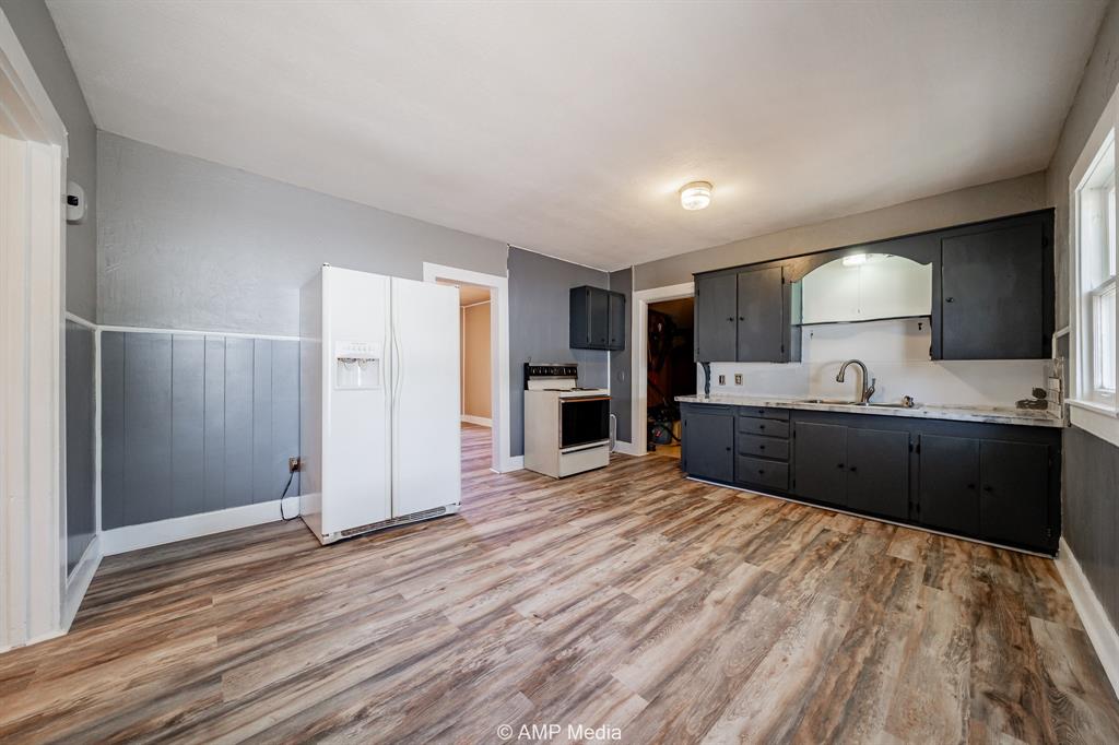 1726 Avenue J Anson, TX 79501 - Photo 7 of 13 a view of kitchen with refrigerator microwave and cabinets