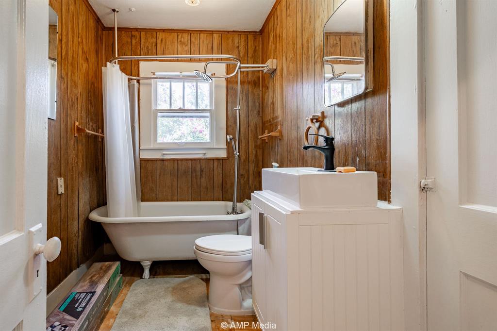 1726 Avenue J Anson, TX 79501 - Photo 8 of 13 a bathroom with a sink toilet and shower