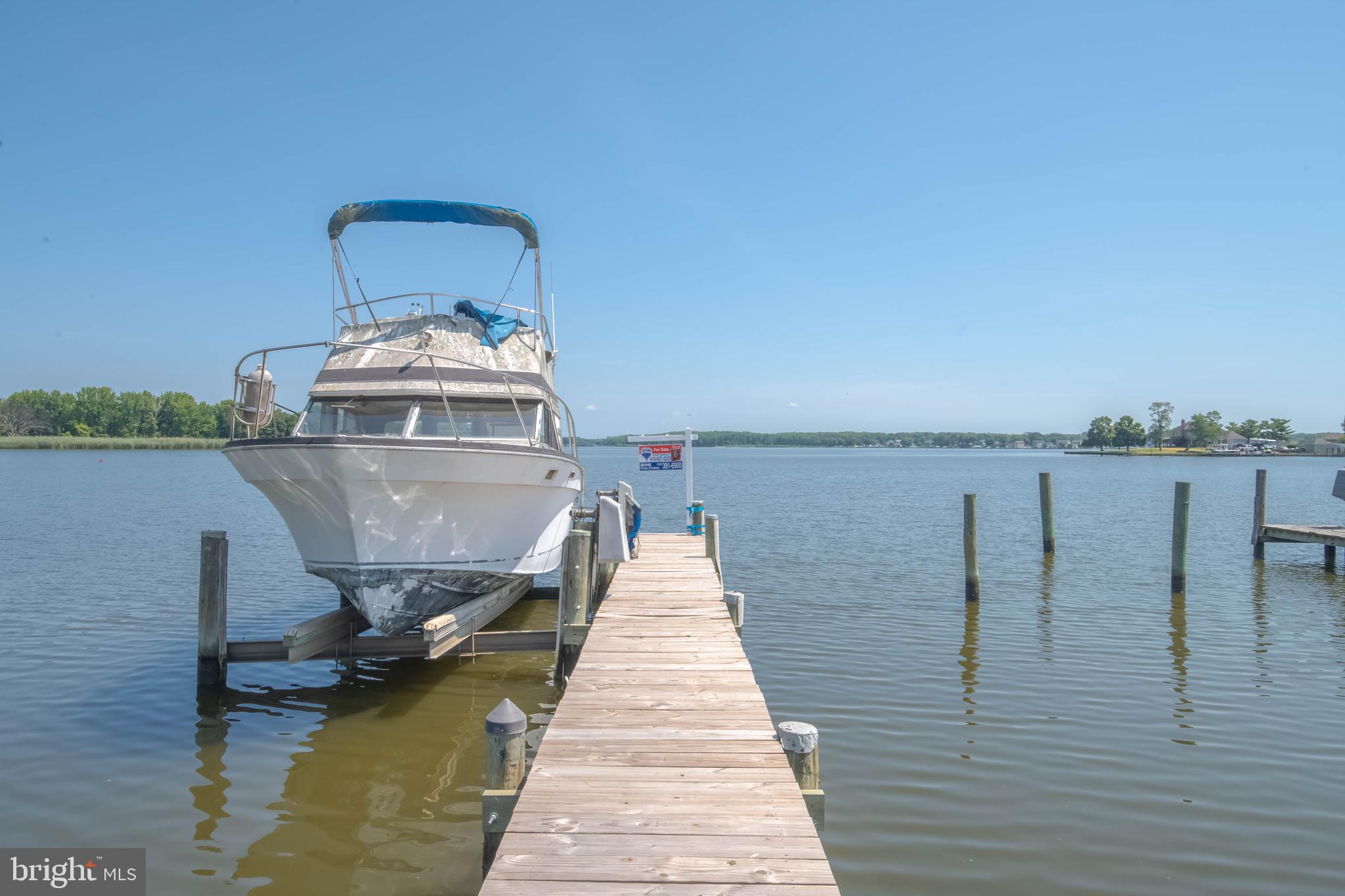 6610 River Drive Road Baltimore, MD 21219 - Photo 8 of 30 a wooden pier with boats and a lake view