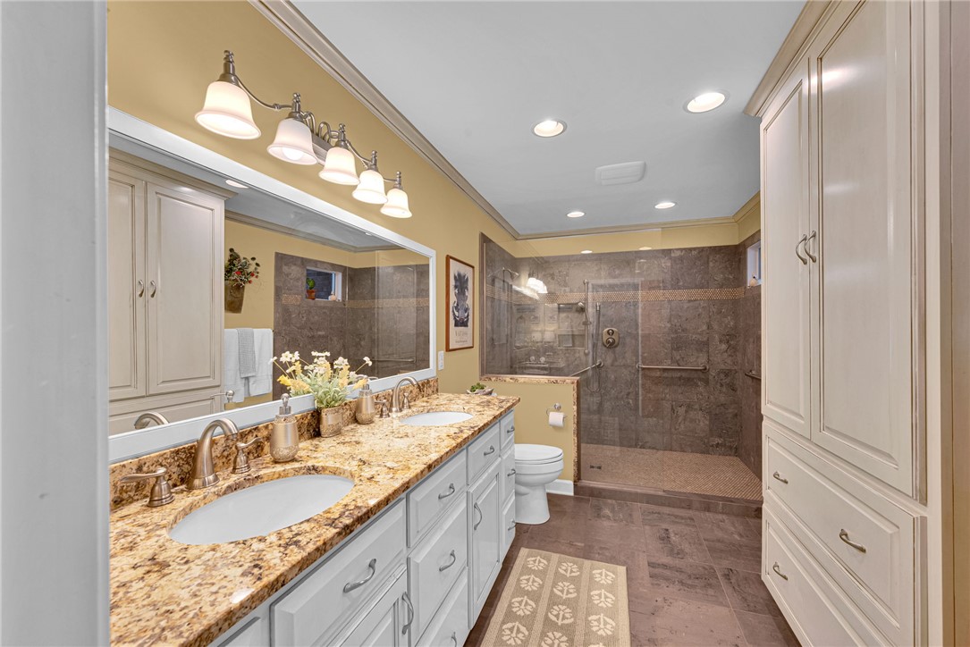 1010 Ridgeview Drive Pendleton, SC 29670 - Photo 25 of 47 This primary bathroom features a double vanity with granite counters and a spacious walk-in shower.